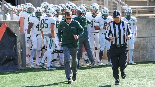 Buddy Teevens leading team onto field