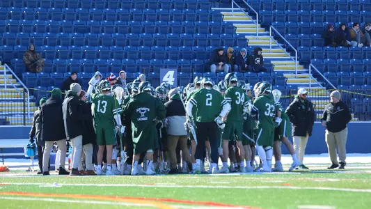 Huddle men's lacrosse action versus Merrimack