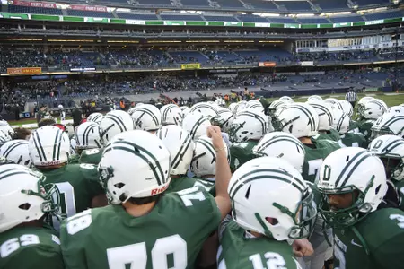 Players gather on the field at Yankee Stadium before playing Princeton, Nov. 9, 2019