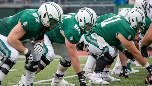 Griff Lehman, Calvin Atkeson and Evan Hecimovich ready for a play against Yale, Oct. 9, 2021