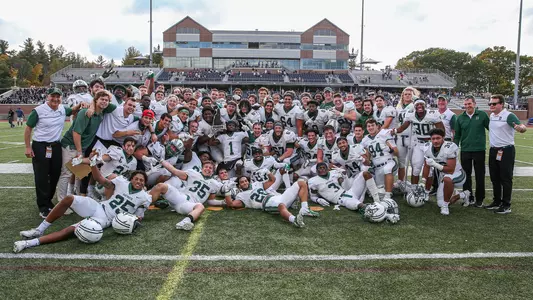 Dartmouth hoists the Granite Bowl Trophy after the 38-21 win over #23 UNH, Oct. 16, 2021