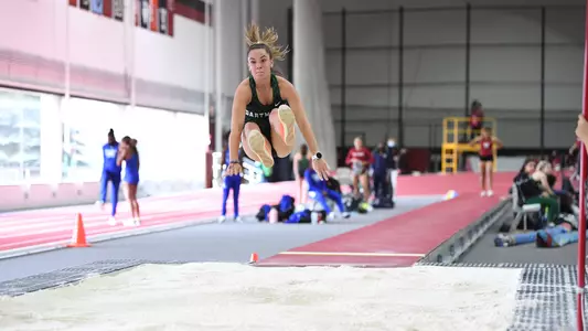 Bridget McNally jumping at Harvard track meet