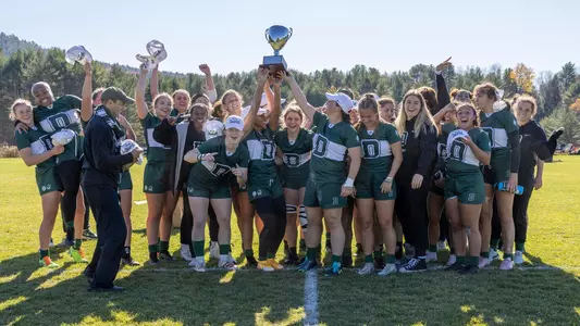 Team with trophy women's rugby action versus Brown