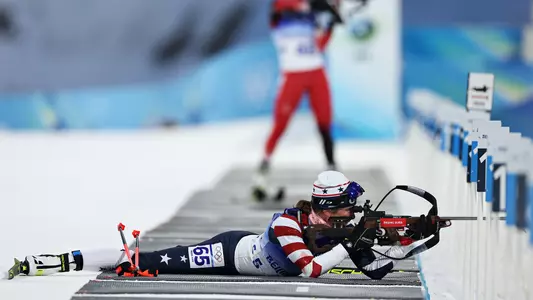 Susan Dunklee ’08 takes aim from the prone position during the 7.5K pursuit at the 2022 Winter Olympics