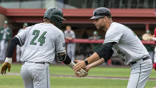 Kade Kretzschmar is congratulated by third base coach Mike Odenwaelder after his home run in the second game at Cornell, April 23, 2022