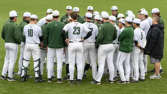 Big green huddle during baseball action versus Massachusetts