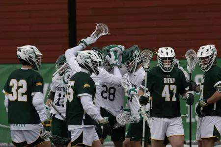 Men's Lacrosse celebrates a goal against Siena