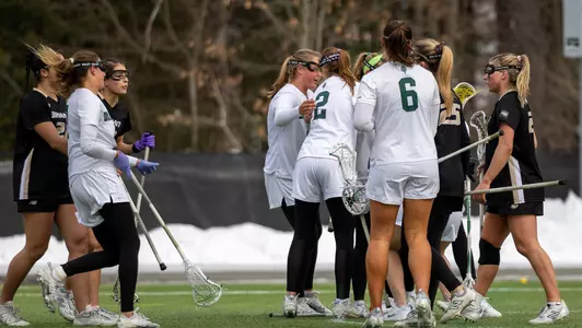 WLAX celebrates a goal vs Bryant