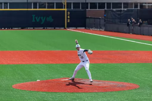 Mac Burke pitches at home