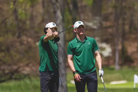 Brand and Harper look at a hole