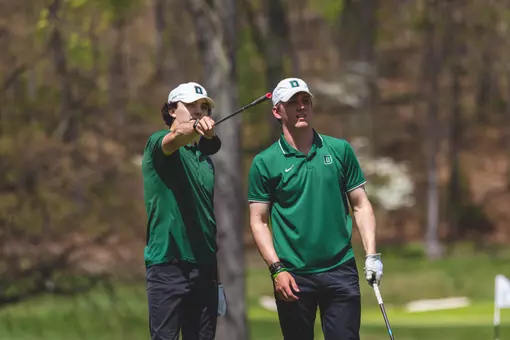 Brand and Harper look at a hole