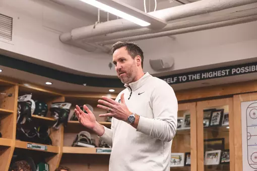 Cashman speaking to the team in the locker room