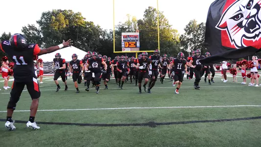 Photo of football team running out