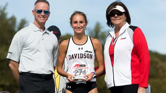 Photo of Maddie Hunter accepting A-10 All-Conference trophy