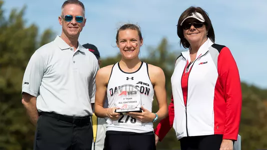 Photo of Sarah Sears accepting her A-10 All-Conference trophy