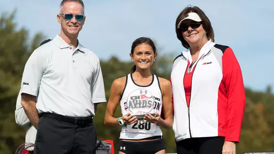 Photo of Caroline Yarbrough accepting her A-10 All-Conference trophy