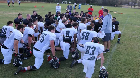 Photo of Spring Practice huddle with Paul Nichols