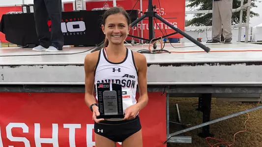 A photo of Caroline Yarbrough and her All-Conference trophy