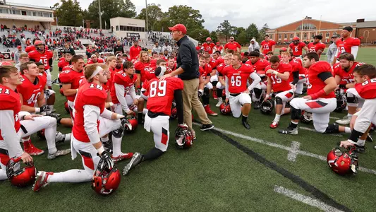A photo of the team huddling after the Stetson game