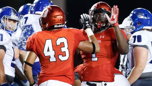 A photo of TJ Elliott and Tony Collins high-fiving