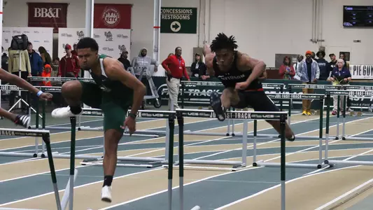 A photo of Jordan Benson hurdling