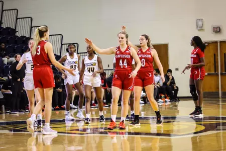 Issy Morgan high-fives Elle Sutphin in non-conference action at UNCG