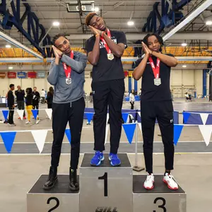Jayden Smith, Jordan Benson, and Isaac Bynum pose on the A-10 podium after sweeping the 60H