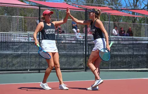 Franny Shea and Emma Heiderscheit high-five during a doubles match, 2022