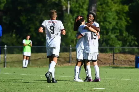 Alonzo Clarke celebrates with teammates after scoring against Presbyterian on Aug. 31, 2023