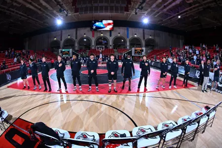 WRES stands during the national anthem against Queens