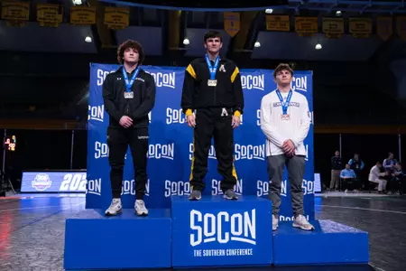 Tanner Peake stands on the podium after taking second place at the 2024 SoCon Championships