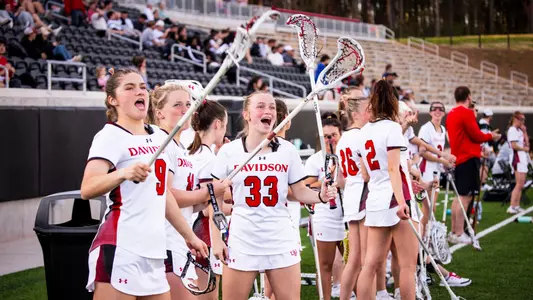 Davidson lacrosse sidelines cheering against VCU