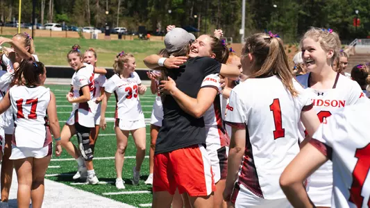 Kim Wayne and Brynn Jones huggin after defeating Saint Joseph's 10-9