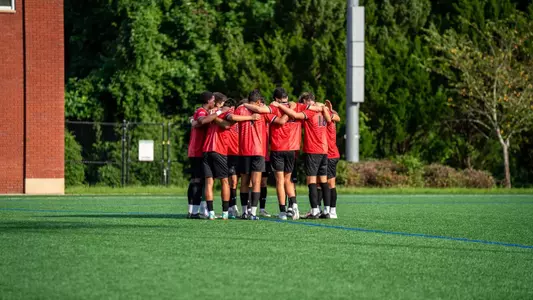 Men's Soccer Team Huddle at Queens on August 15, 2025