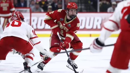 ST PAUL, MINNESOTA - APRIL 11: Sean Behrens #2 of the Denver Pioneers skates with the puck against the Boston University Terriers in the third period during the Division I Men?s Ice Hockey Semifinals held at Xcel Energy Center on April 11, 2024 in St Paul, Minnesota. (Photo by Tyler Schank/NCAA Photos via Getty Images)