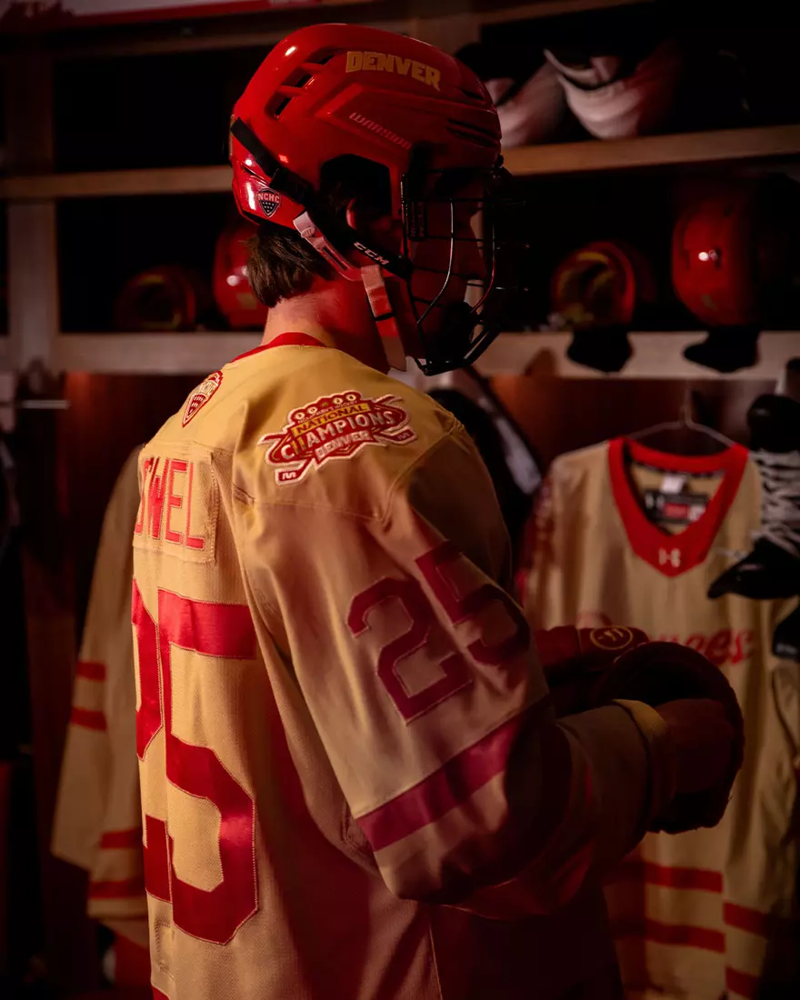 The Denver Pioneers hockey team reveals a new 'Golden Age' jersey to be worn on Friday, October 16, 2026 for the faceoff against the No. 2 Michigan and the 11th National Championship Banner.