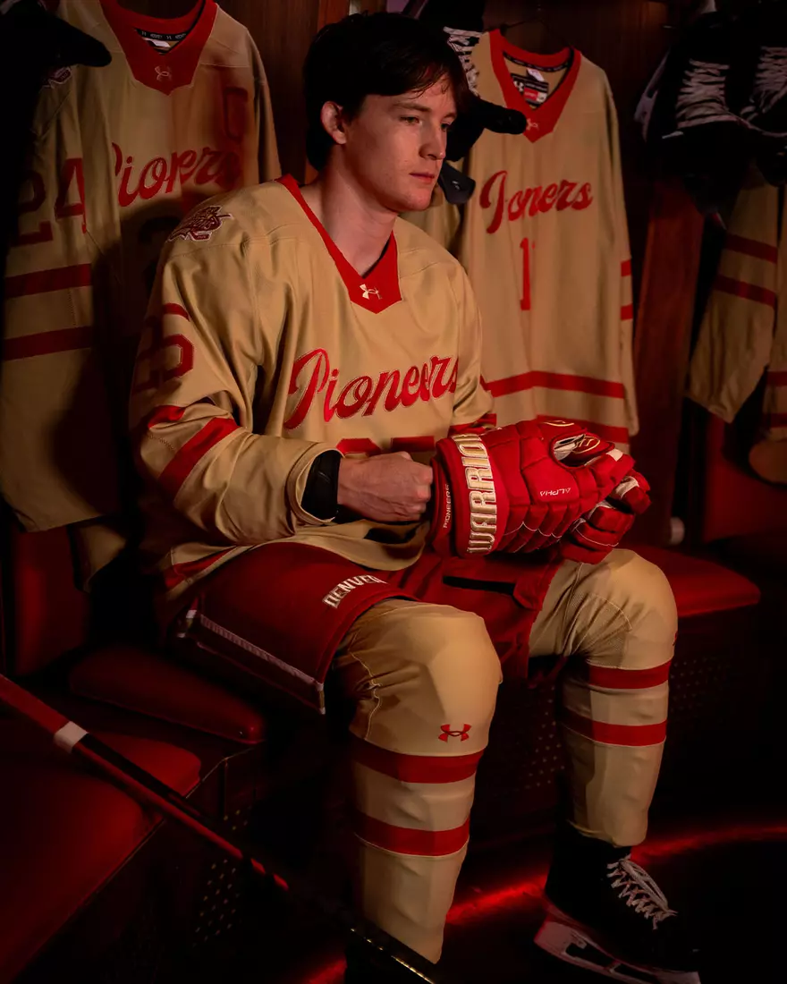 The Denver Pioneers hockey team reveals a new 'Golden Age' jersey to be worn on Friday, October 16, 2026 for the faceoff against the No. 2 Michigan and the 11th National Championship Banner.