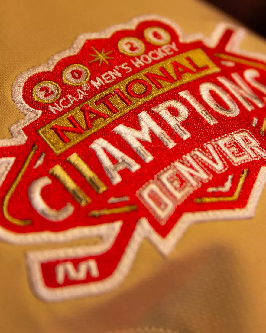 The Denver Pioneers hockey team reveals a new 'Golden Age' jersey to be worn on Friday, October 16, 2026 for the faceoff against the No. 2 Michigan and the 11th National Championship Banner.