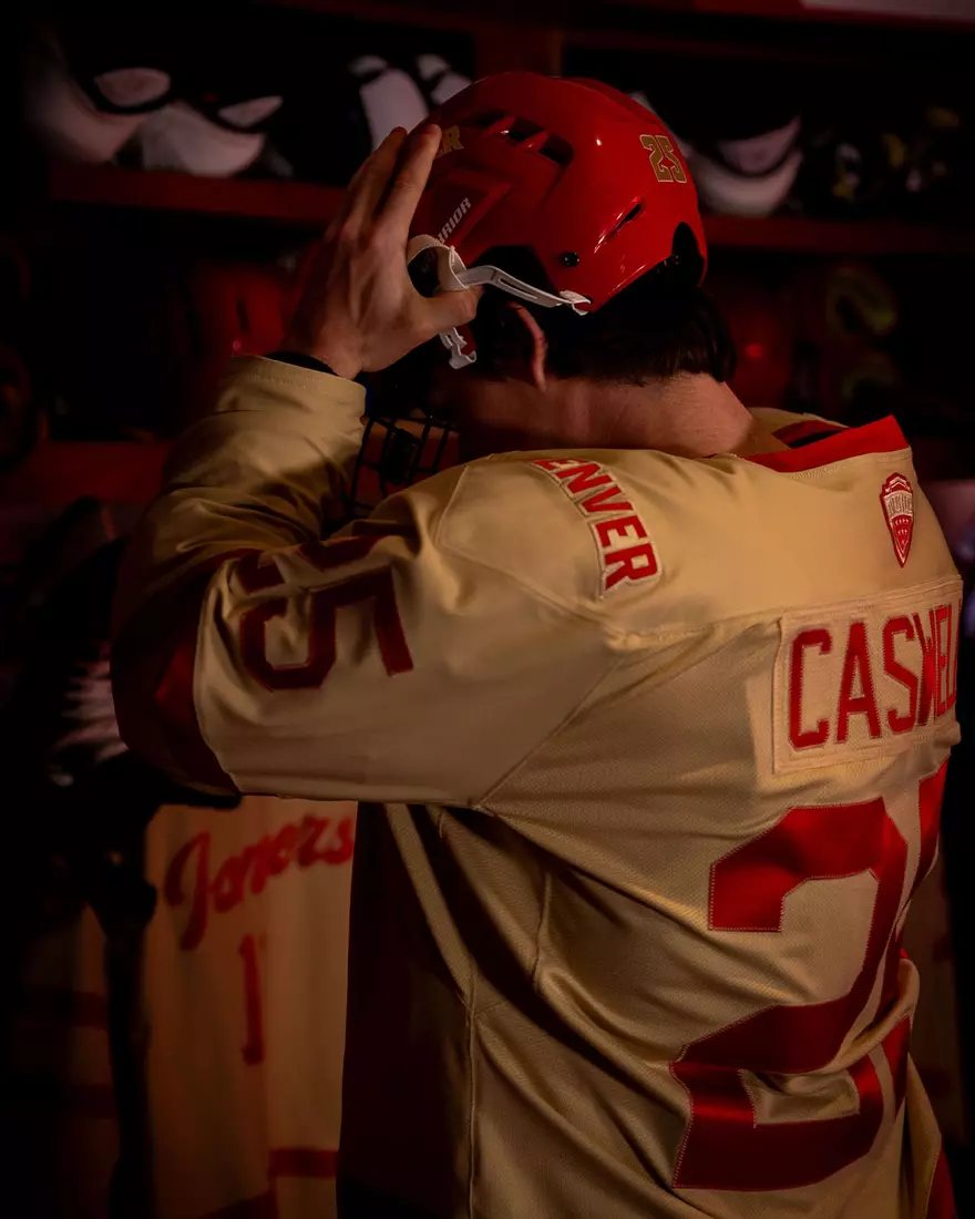 The Denver Pioneers hockey team reveals a new 'Golden Age' jersey to be worn on Friday, October 16, 2026 for the faceoff against the No. 2 Michigan and the 11th National Championship Banner.