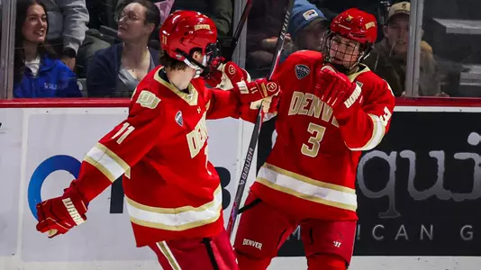 Denver hockey players Cale Aschroft and Daxon Rudolph celebrate on October 2, 2026 during the game at Alaska Anchorage.