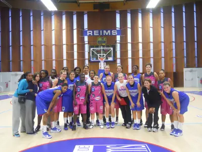 The Blue Demons and Reims pose for a photo after DePaul's 75-70 victory on Tuesday.