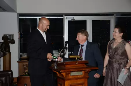 Dave Dopek receives the symbolic baton pass from Pat Savage