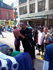 Donnavan Kirk lines up an attempt at the Pop-A-Shot exhibit during last Saturday's Open Streets festival.