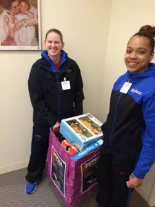 Kelsey Reynolds and Brittany Hrynko prepare to deliver toys to a classroom at Saint Vincent de Paul