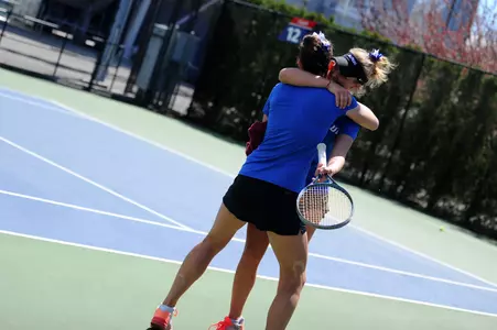 Fargas (back) celebrates DePaul's BIG EAST Tournament crown with teammate Rebeca Mitrea (front).