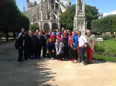Blue Demons pose for a team photo after visiting Notre Dame Cathedral in Paris.