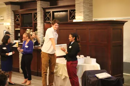 Men's and women's basketball student-athletes Peter Ryckbosch and Chanise Jenkins picking out raffle winners.
