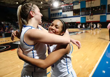 Seniors Megan Podkowa and Chanise Jenkins embrace as they exit the game with 7:01 to play in the 4th quarter.