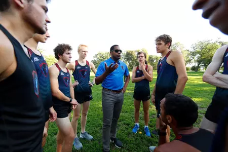 Coach Peterson coaching cross country 2018