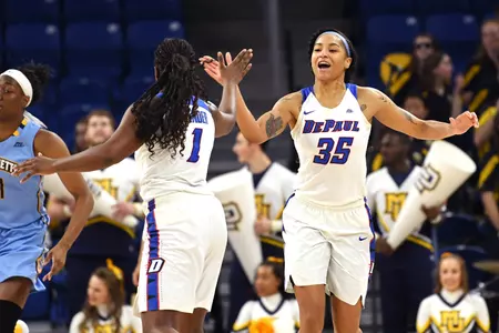 Mar 6, 2018; Chicago, IL, USA; DePaul Blue Demons forward Mart'e Grays (35) celebrates with guard Ashton Millender (1) during the first half of the championship game against the Marquette Golden Eagles in the women's Big East Conference tournament at the Wintrust Arena. Mandatory Credit: Patrick Gorski-USA TODAY Sports